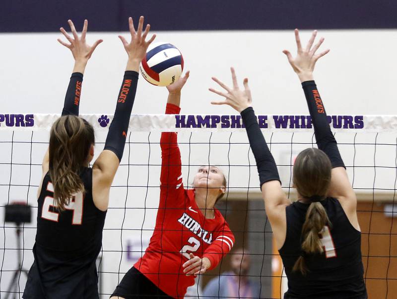 Huntley's Rachael Hein (center) hits the ball between Libertyville's Claire Evans (left) and Vivian Lang (right) during an IHSA Class 4A Hampshire Sectional semifinal volleyball match on Tuesday, Nov. 4, 2025, at Hampshire High School.