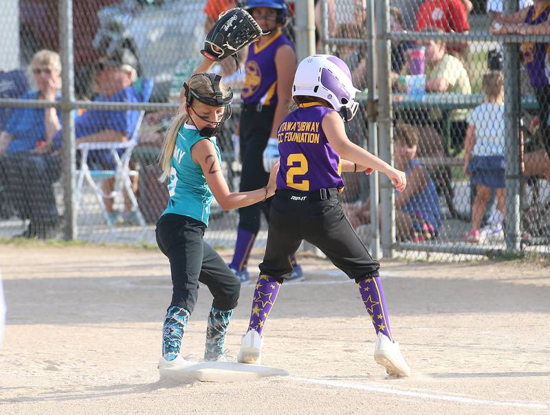 Edge's third baseman Kaylee Jerde misses a tag on Warriors Grace Poggi during the Ottawa Girls Fastpitch Association 11U City Championship on Wednesday July 2, 2025 at Peck Park in Ottawa.