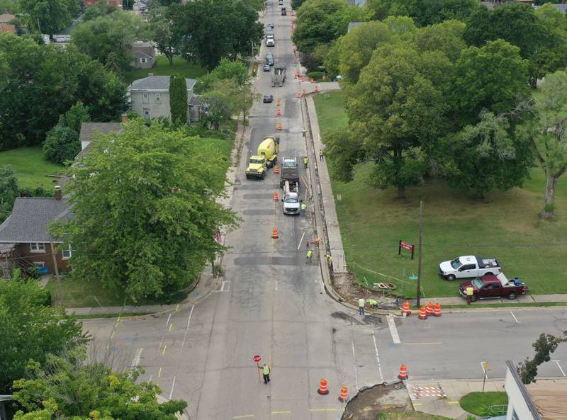 Workers replace a curb and a sidewalk near the intersection of 5th Street and Crosat Street on Monday, July 29, 2024 in La Salle. A long-term construction project is in full swing involving road patching, milling and resurfacing U.S. Route 6 from La Salle to Peru. In addition to roadwork, crews are rebuilding sidewalk ramps, drainage repairs, signal improvements and install raised reflectors. The 6.4 million project is expected to be fully completed by the end of summer 2025. Motorists are advised to use caution and be aware of traffic signals through the construction zones, which may cause increased wait times.