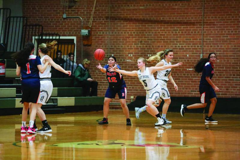 St. Bede’s Grace Maschmann (No. 5) bursts in front of a DePue player for a steal during regional play at St. Bede Monday night.