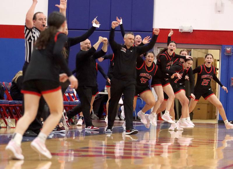 Huntley’s Red Raiders rejoice as Luca Garlin drains a half-court shot to conclude the first quarter against Maine South in Komaromy Holiday Classic varsity girls basketball championship game action on Monday, Dec. 30, 2024, at Dundee-Crown High School in Carpentersville.