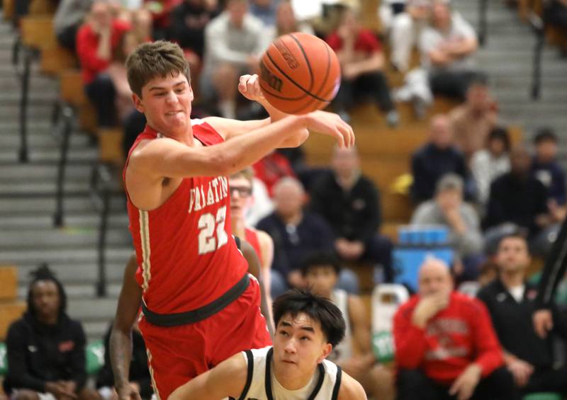 Palatine’s Tommy Elter swats the ball away during the Jack Tosh Holiday Classic semifinals against Bolingbrook at York High School in Elmhurst on Friday, Dec. 29, 2023.