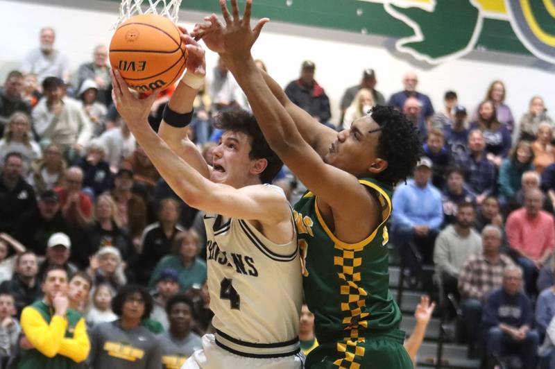 Crystal Lake South’s David McFadden, right, battles Cary-Grove’s Dylan Dumele for a rebound in boys IHSA Class 3A Regional Championship basketball on Friday, Feb. 27, 2026, at Crystal Lake South High School in Crystal Lake.