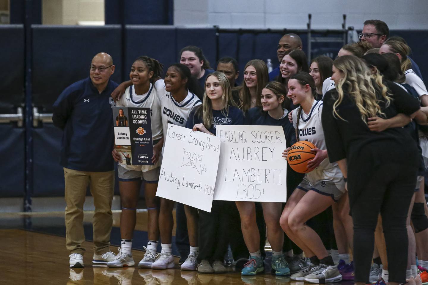 Aubrey Lamberti poses with teammates during a stoppage of play recognizing her breaking the girls all time scoring record during their basketball game between Minooka at Oswego East Friday, Jan 16, 2026 in Oswego.