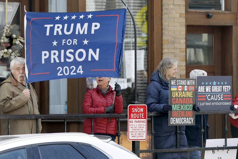Protesters line U.S. Route 12 in Richmond to protest their discontent with President Donald Trump and his administration's policies on Saturday, April 19, 2025. Over 100, people took part in the Richmond protest. A second rally was held in Harvard later in the day.