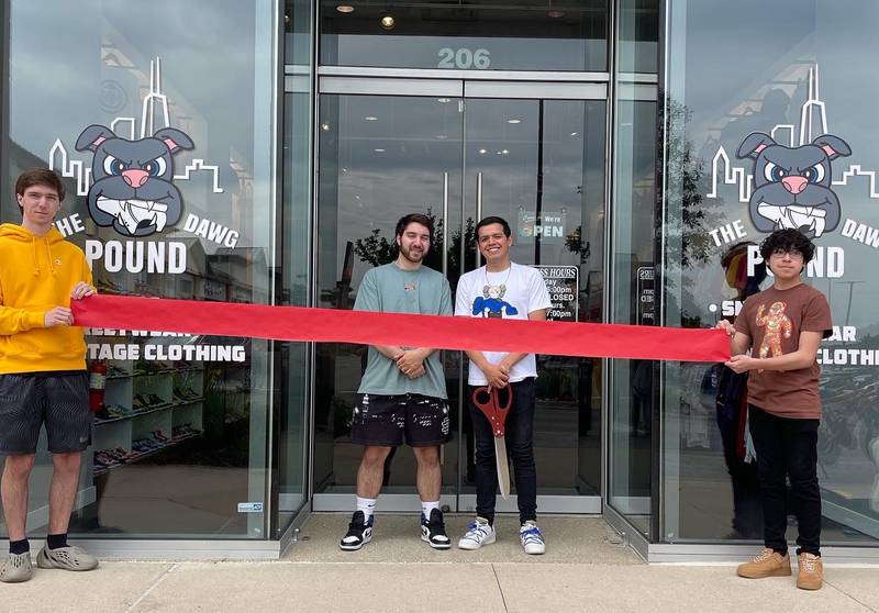 Cutting the ribbon at The Dawg House, 206 Commons Drive, Geneva are Dylan Hintz, (left) co-owners Tyler Hintz and Jonathan Erceg and  Edgar Erceg. The store sells specialty limited edition vintage and streetwear and sneakers.