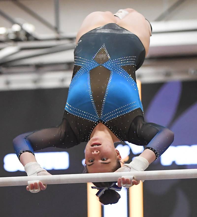 Natalie Simpson of Downers Grove South High School on the uneven parallel bars at the Hinsdale South girls gymnastics sectional meet in Darien on Tuesday, February 7, 2023.