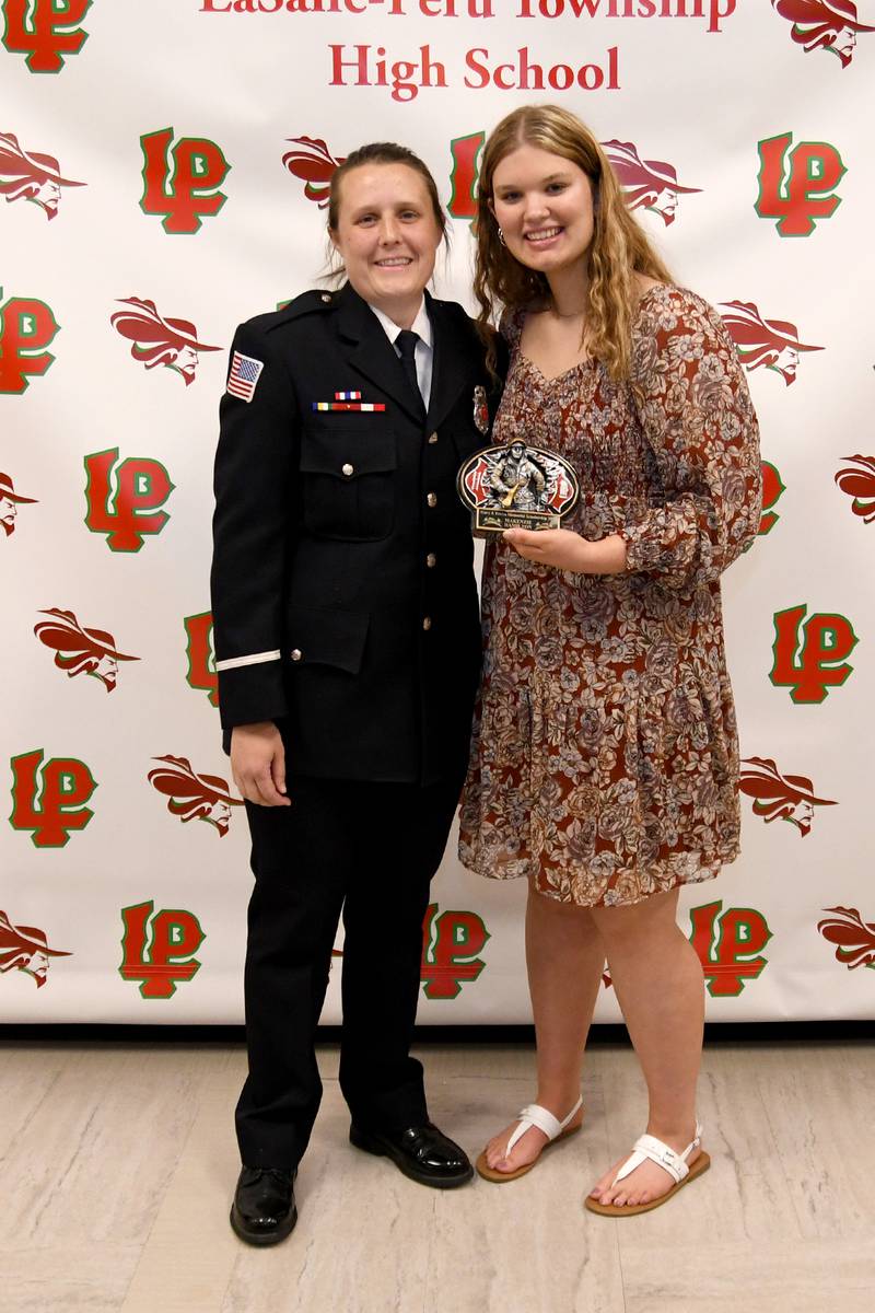 Makenzie Hamilton (right) received the Gary Eccles Scholarship, presented by fire science teacher Robbyn Partain. The $500 scholarship is awarded to an L-P senior entering an emergency services career and who will attend Illinois Valley Community College.