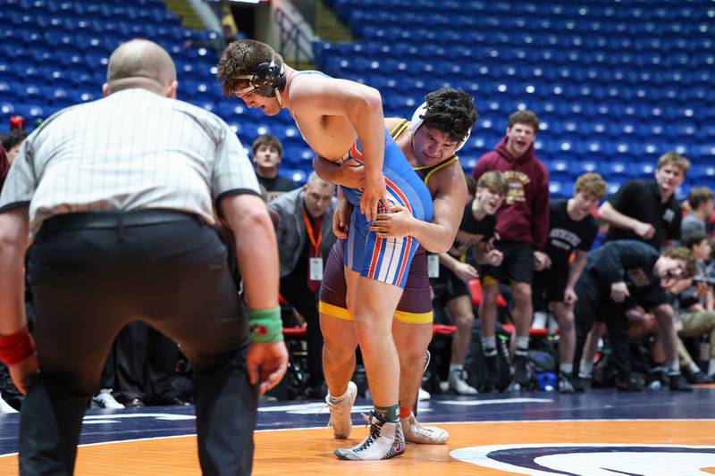 Montini's Sam Swais lifts Marmion Academy's Luke Boersma in the 215-pound match during Marmion Academy's victory over Montini in the IHSA Class 3A Dual Team State championship on Saturday, Feb. 28, 2026.