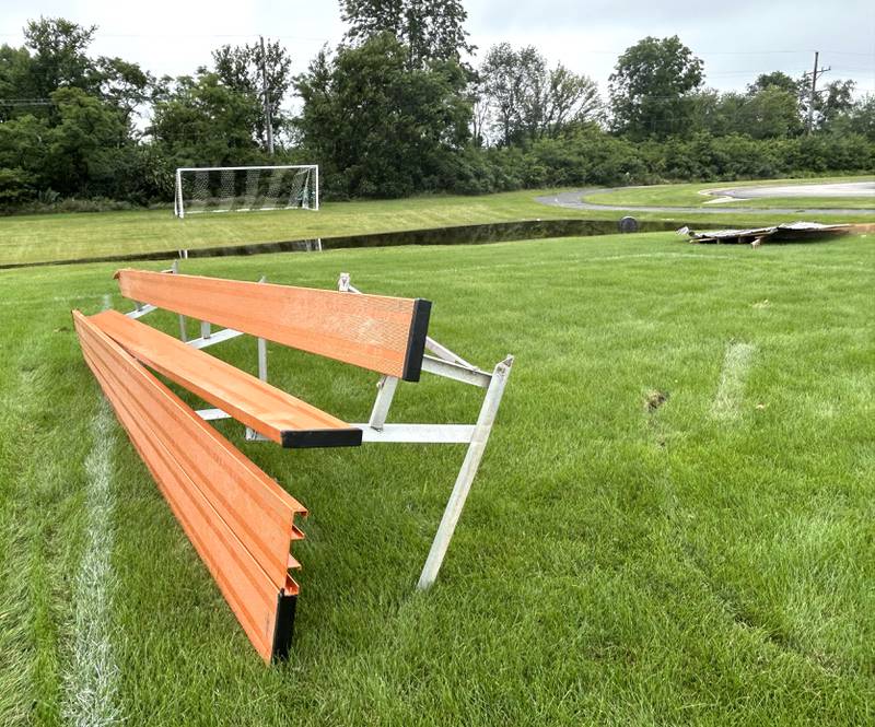 A twisted bench lays on the Byron High School soccer field with other storm debris on Tuesday, July 16, 2024.
