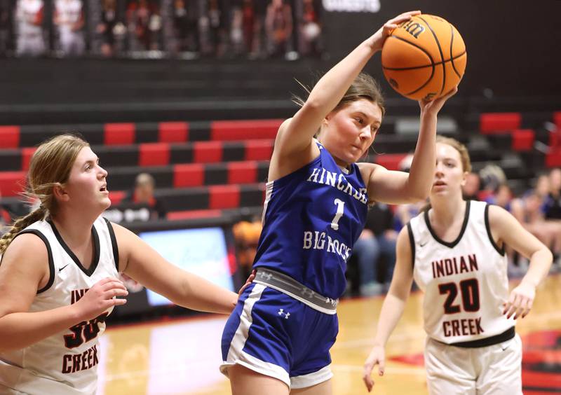 Hinckley-Big Rock's Payton Murphy grabs a rebound between two Indian Creek defenders during their game Monday, Jan. 13, 2025, at Indian Creek High School in Shabbona.