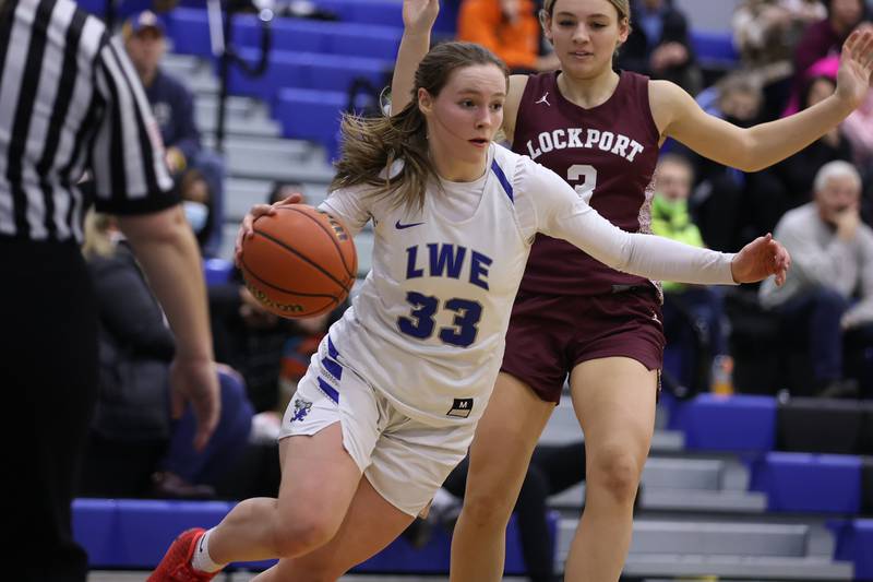 Lincoln-Way East’s Lana Kerley drives along the baseline against Lockport in the Class 4A Lincoln-Way East Regional semifinal. Monday, Feb. 14, 2022, in Frankfort.