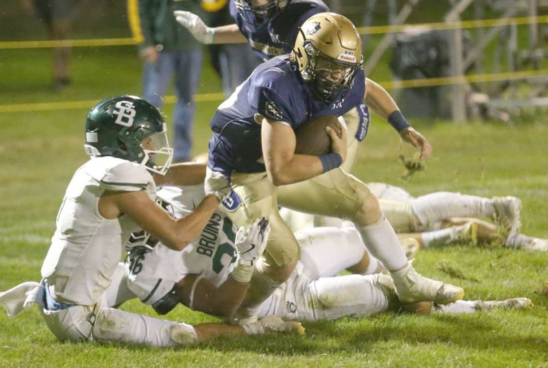 Marquette's Jaxsen Higgins gets out of a tackle from St. Bede defenders Jose De Le Torre and Landon Marquez on Friday, Sept. 26, 2025 at Gould Stadium in Ottawa.
