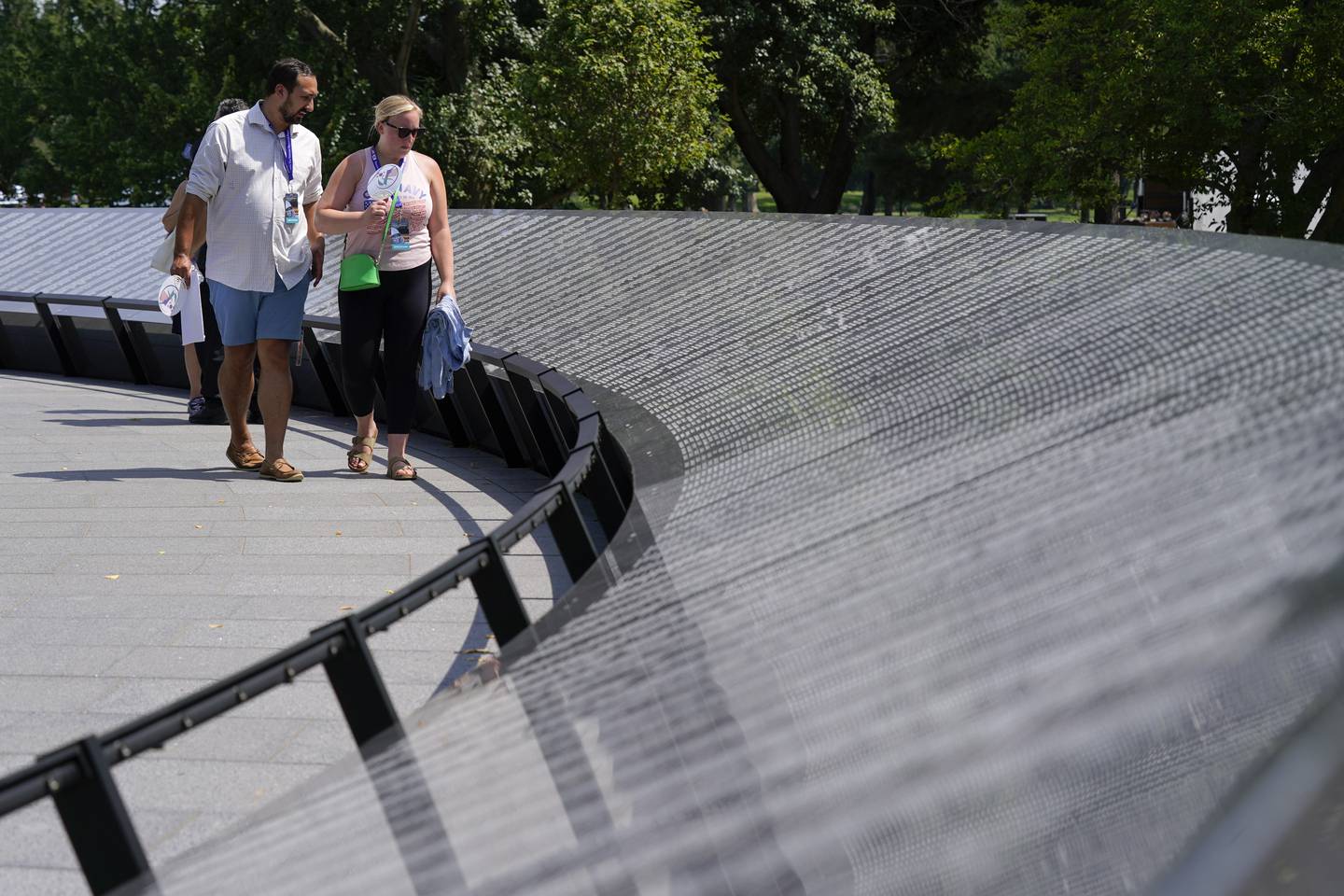 Visitors walk past the Korean War Veterans Memorial's newly unveiled Wall of Remembrance after a dedication ceremony on July 27, 2022, in Washington.