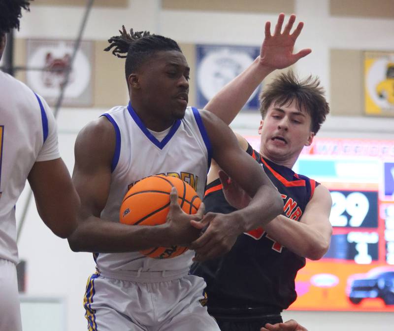 Warren’s Javerion Banks, left, snags a rebound in front of McHenry’s Carter Sites in IHSA Class 4A Regional Title Game boys basketball action on Friday, Feb. 28, 2025 at McHenry High School in McHenry.