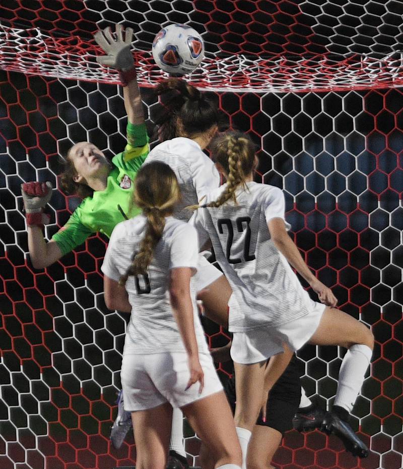 Lincoln-Way Central goalkeeper Alexa Hadley makes a save against a host of Metea Valley players in the Class 3A IHSA state girls soccer semifinal game in Naperville on Friday, June 3, 2022.