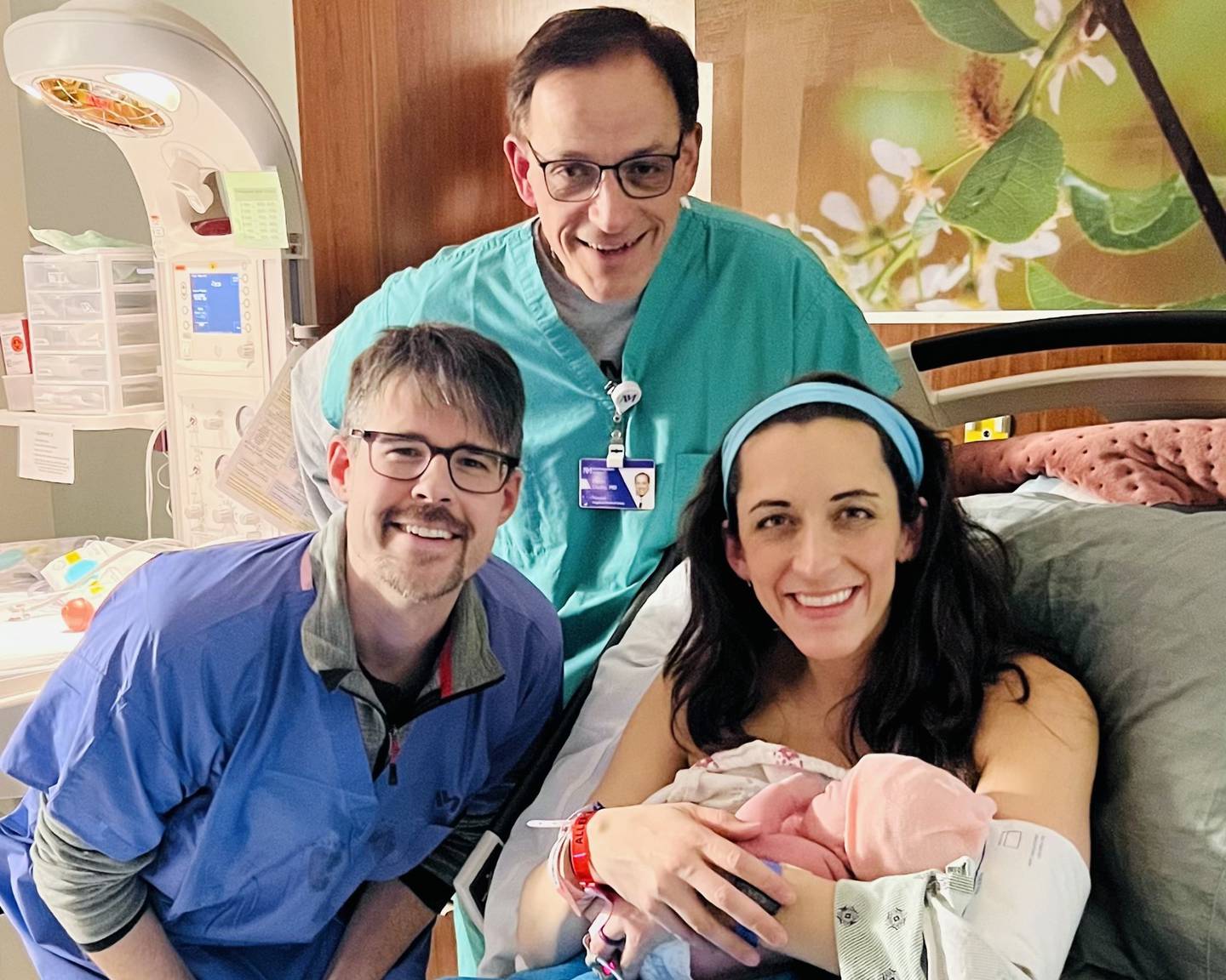 Andrea and Matthew Hodge and Andrea's father, Dr. Peter Cladis, pose with newborn Pearl Noelle Hodge, after she was born on New Year's Day, 2024 at Northwestern Medicine Delnor Hospital in Geneva.