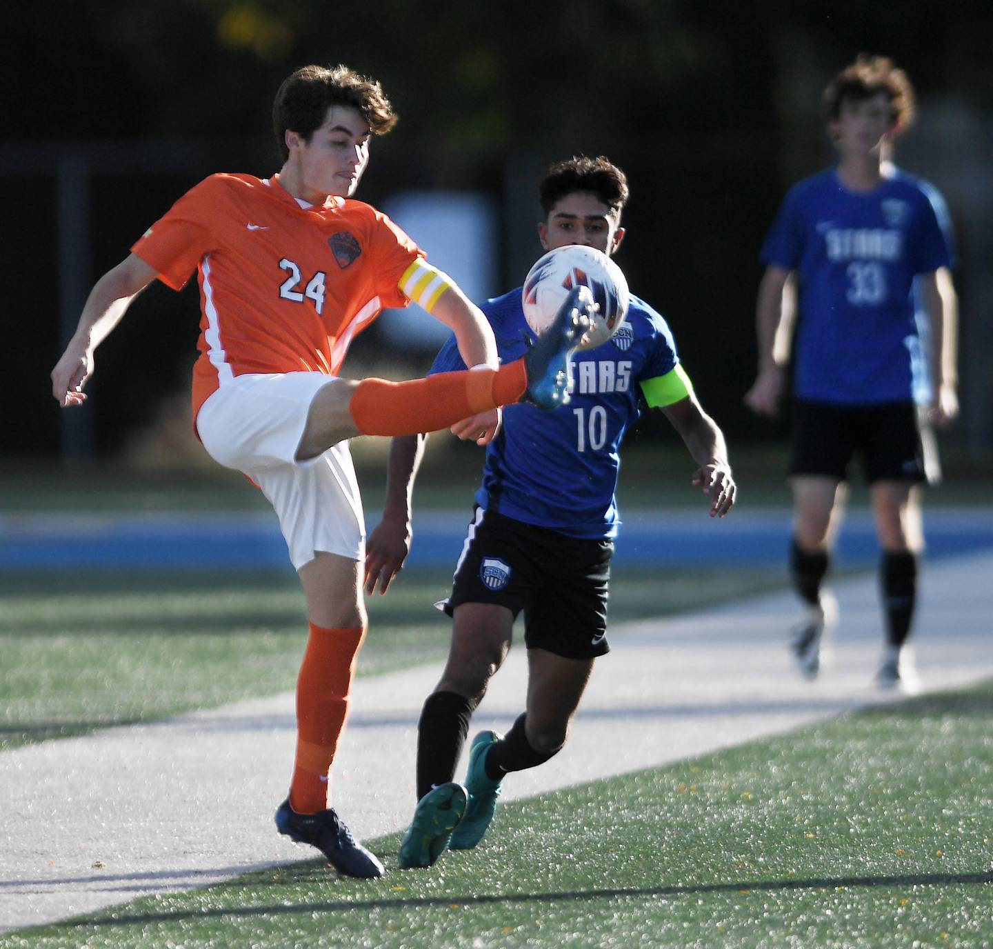 John Starks/jstarks@dailyherald.com
St. Charles East’s Ryan Vandeveer kicks the ball in front of St. Charles North’s Devan Girish in the TriCities boys soccer night game in Geneva on Tuesday, September 27, 2022.