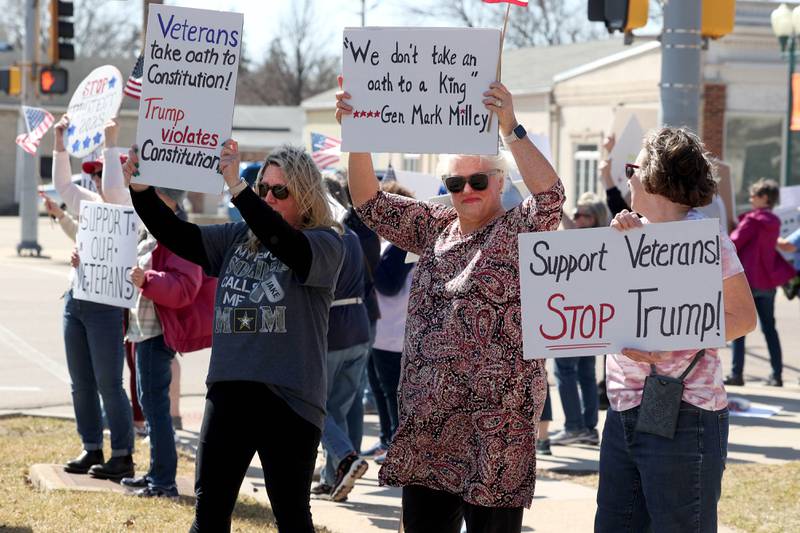 Protesters gather to voice their displeasure with President Donald Trump Friday, March 14, 2025, in front of the DeKalb County Courthouse in Sycamore. The group was protesting recent cuts by the Trump administration to the Department of Veterans Affairs.