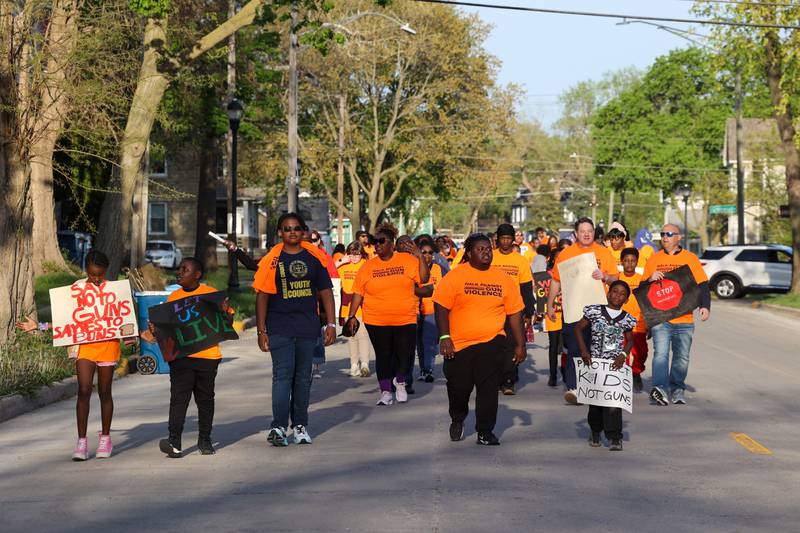 About 100 participants walk through Kankakee during the 2nd Walk Against Gun Violence on Tuesday, April 29, 2025.