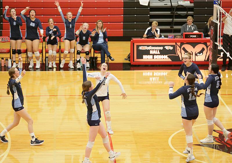Members of the Bureau Valley volleyball team celebrate after defeating Hall in the Class 2A Regional game on Monday, Oct. 24, 2022 at Hall High School in Spring Valley.