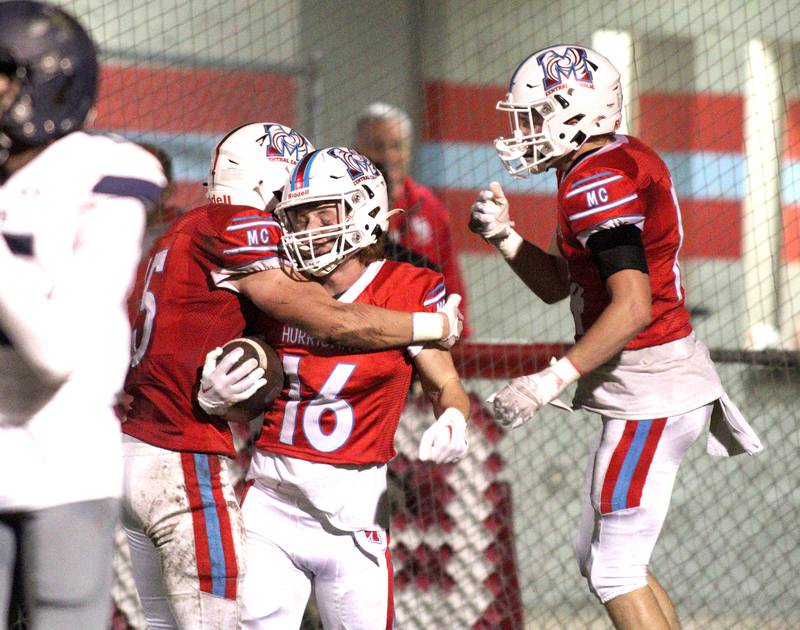 Marian Central’s Jacob Sievert is greeted in the end zone after hauling in a touchdown reception against Chicago Hope in varsity football at Woodstock Friday night