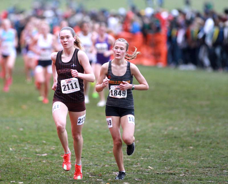 Plainfield North's Tessa Russo (left) and Batavia's Avery Hacker compete in the Class 3A State Cross Country Championships on Saturday, Nov. 9, 2024 at Detweiller Park in Peoria.