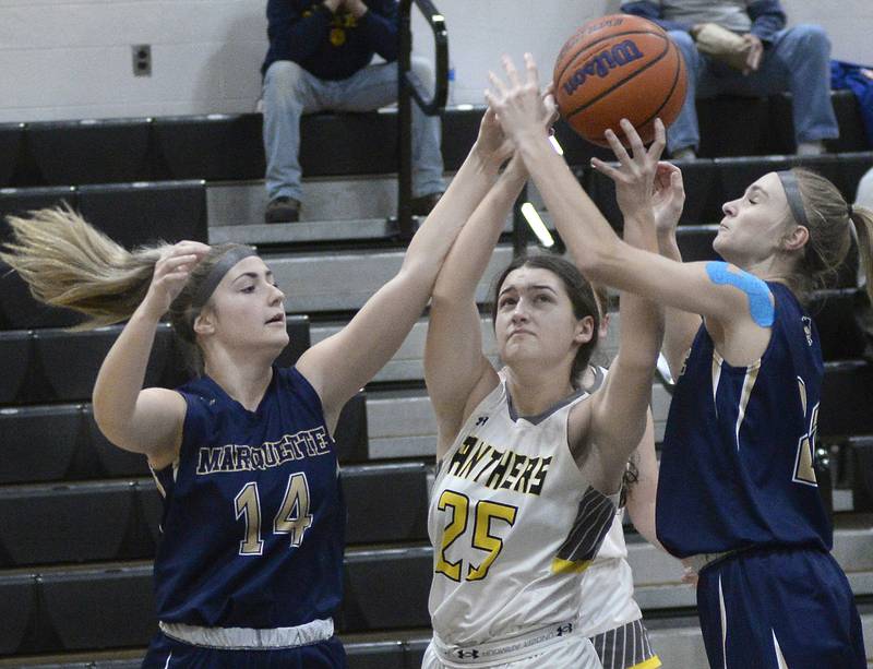 Marquette’s Eva MCallum and Avery Durdan try to block the shot by Putnam County’s Maggie Richetta in the 1st period on Wednesday, Dec. 14, 2022 at Putnam County High School.