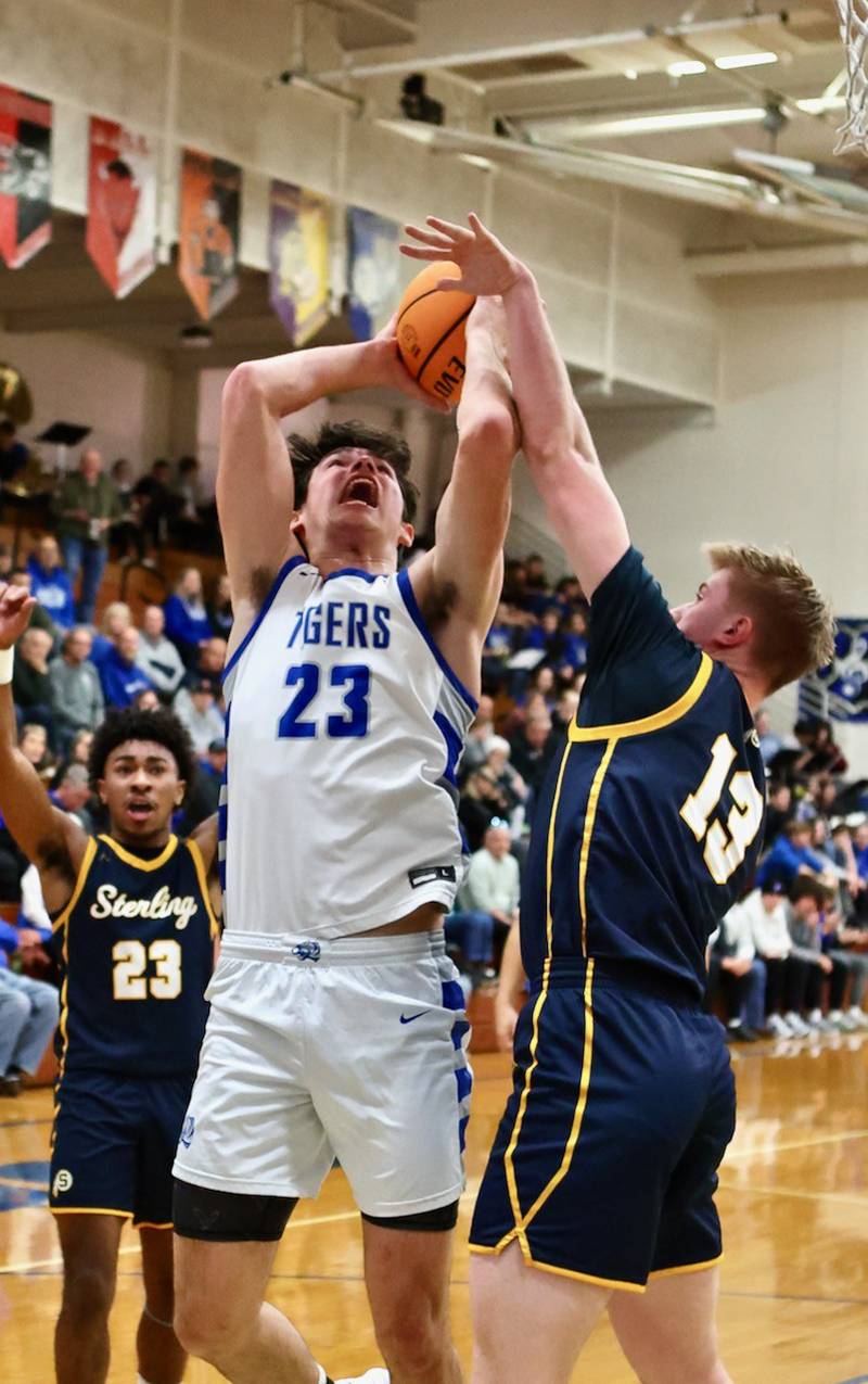 Sterling's Will Ports tries to block a shot by Princeton's Noah LaPorte Friday night at Prouty Gym. The Tigers won 56-47.