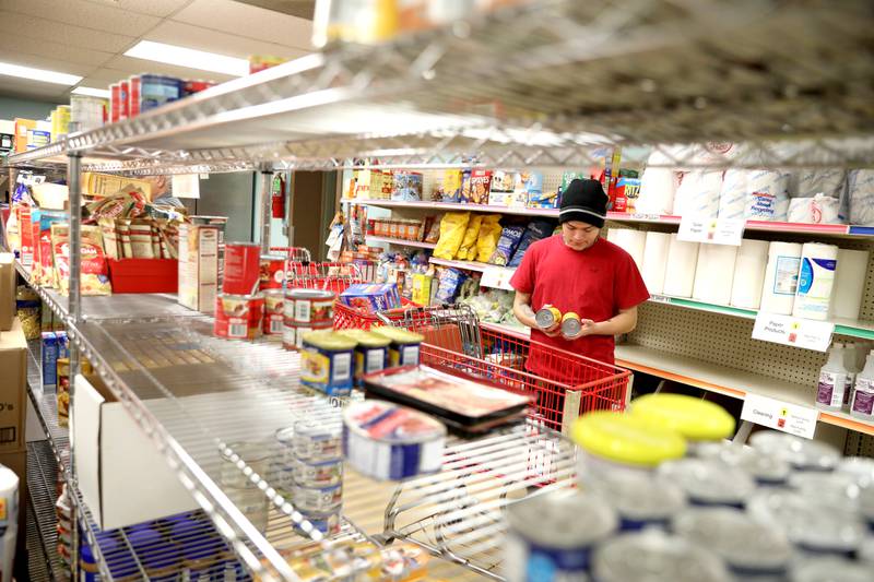 Volunteer Richard Duran stocks shelves at the Batavia Interfaith Food Pantry and Clothes Closet.