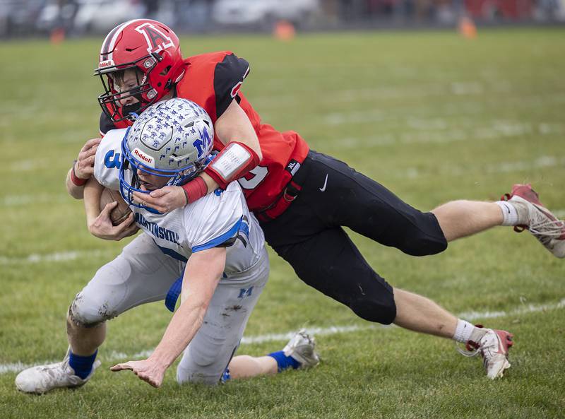 Amboy’s Brayden Klein hauls down Martinsville’s Adam Parcel Saturday, Nov. 9, 2024, in round two of the 8-man football playoffs.