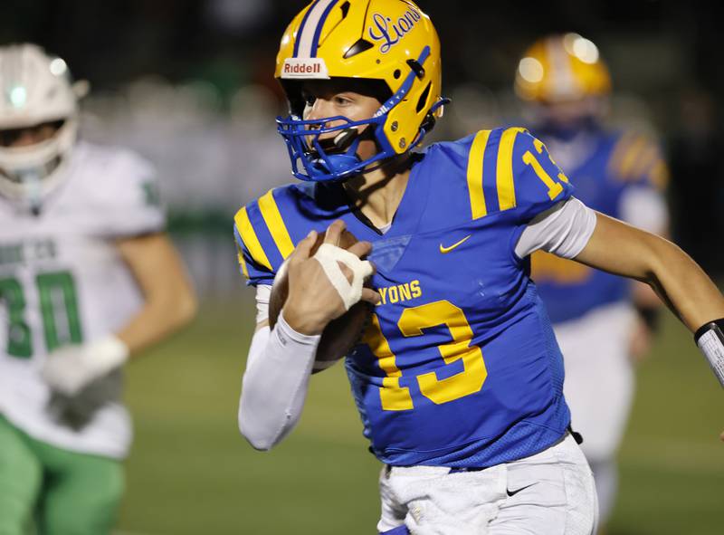 Lyons' Jack Slightom (13) runs the ball during the varsity football first-round 8A playoff game between York and Lyons Township on Friday, Oct. 31, 2025 in Western Springs, IL.