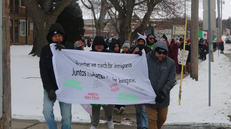 Demonstrators take to the campus of Northern Illinois University Sunday, Feb. 16, 2025, to protest President Donald Trump's immigration policies.