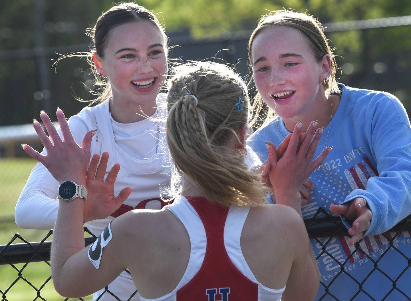 Oregon's Madeline Rogers (center) is congratulated by Lorelai Dannhorn (left) and Ella Dannhorn after finishing first in the 3200 meter run at the 1A Winnebago Sectional on Wednesday, May 13, 2026.