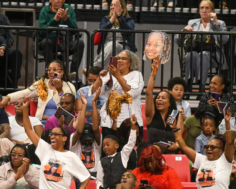 DeKalb High School graduation attendees celebrate their senior after they walked in for the start of the ceremony on Saturday May 23, 2026, held at the Convocation Center in DeKalb.