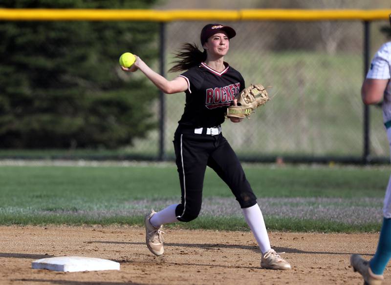 Richmond-Burton's Jocelyn Hird throws to first base as she tries to turn a double play during a Kishwaukee River Conference softball game against Woodstock North on Thursday, April 16, 2026, at Woodstock North High School.