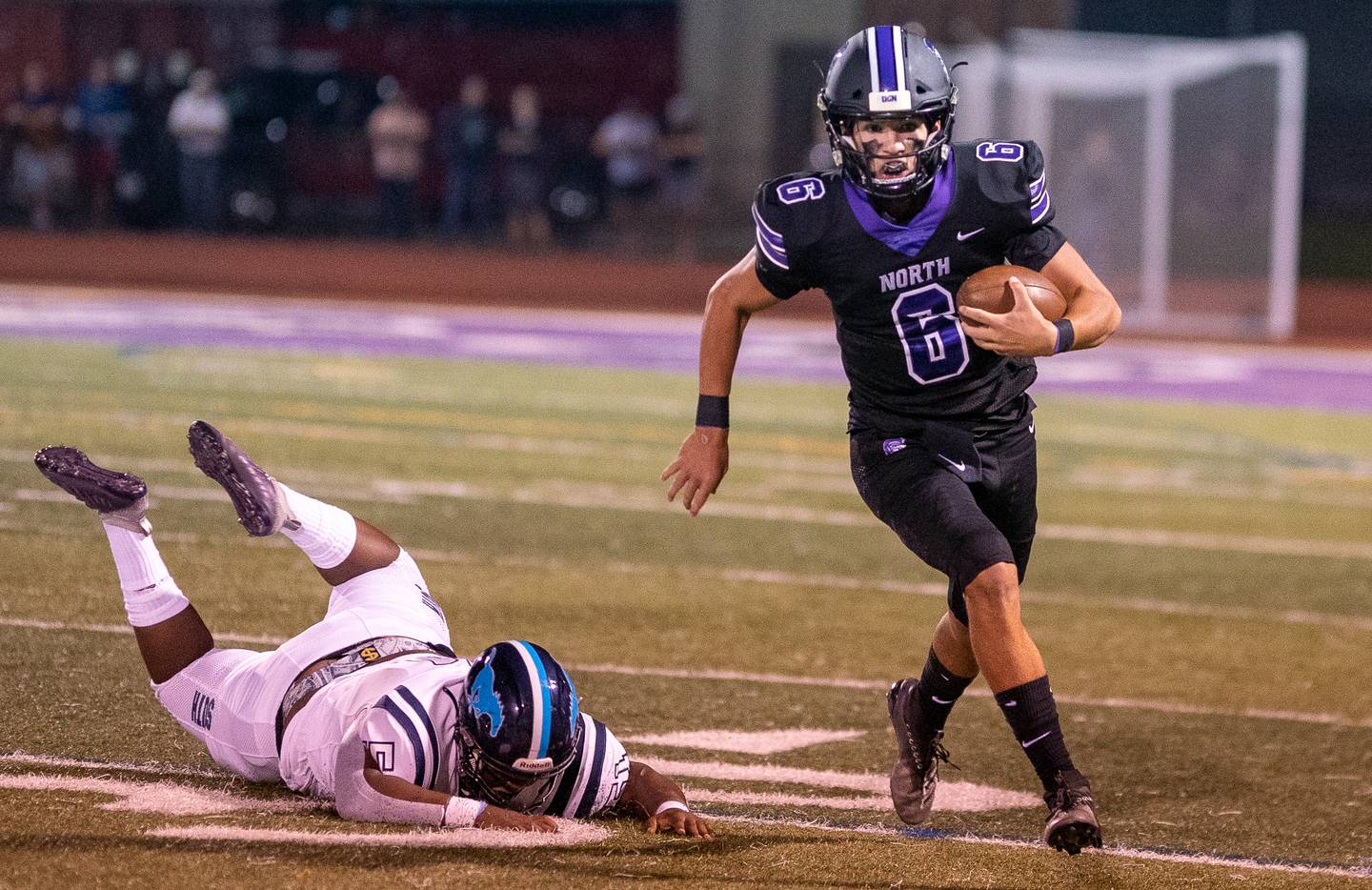 Downers Grove North's Sam Reichert (6) carries the ball on a keeper against Downers Grove South during a football game at Downers Grove North High School on Friday, Sep 9, 2022.