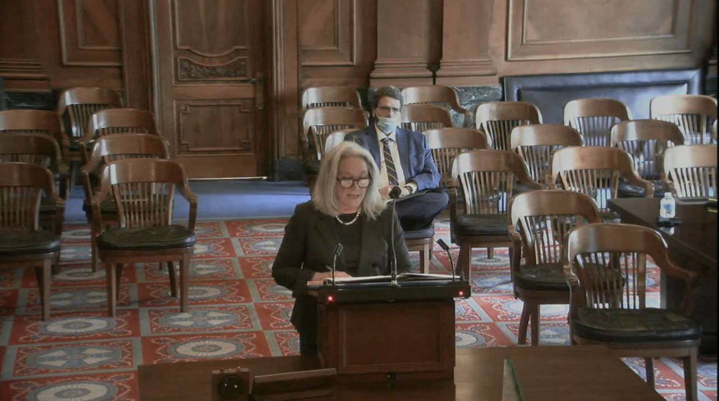 A screenshot from Illinois Supreme Court video shows McHenry County State's Attorney's Office lawyer Carla Wyckoff arguing at the Illinois Supreme Court on behalf of McHenry County Clerk Joe Tirio, pictured rear, on Jan. 19, 2022. Tirio is challenging an appellate court ruling that he erred by striking a McHenry Township referendum to abolish the township government from the November 2020 ballot because voters already turned down a similar abolition referendum in a previous election just months before.