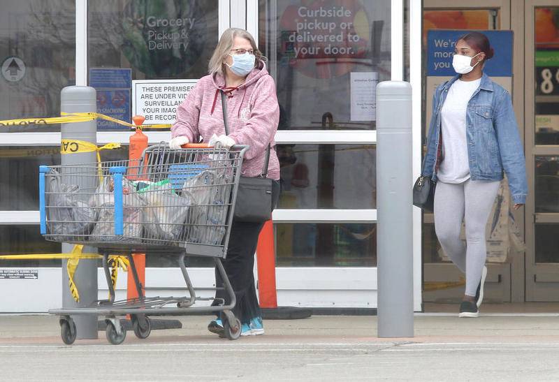 Shoppers wearing protective masks exit the Walmart in DeKalb Thursday afternoon. Illinois Gov. JB Pritzker announced in his daily press conference that beginning May 1, people in Illinois over the age of 2 will be required to wear a face-covering or mask “when in a public place where they can’t maintain a six-foot social distance.”