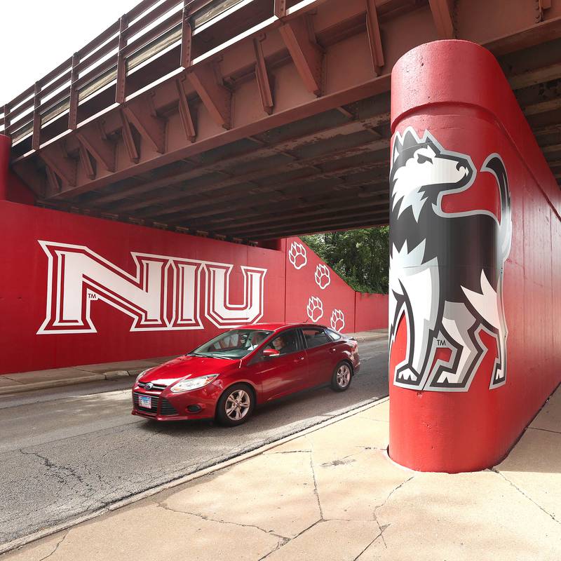 A vehicle drives by part of the new Huskie mural Monday, Aug. 14, 2023, on the Annie Glidden Road railroad underpass, just south of Lincoln Highway in DeKalb. The mural was a joint project between the City of Dekalb and Northern Illinois University.