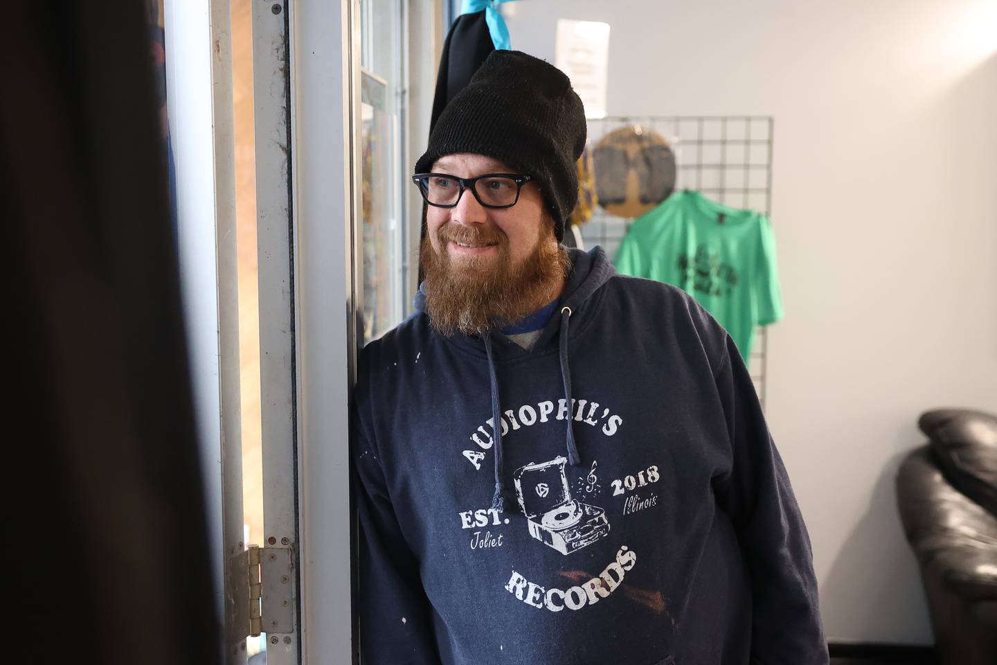 Owner Phil Johnson works the door limiting the number of customers in the store for Audiophil’s Records’ new location opening day on National Record Store Day on Saturday, April 20, 2024 in Joliet.