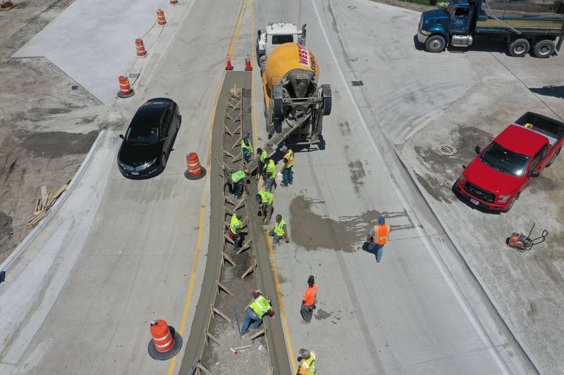 Crews pour concrete on the northern approach to the roundabout on Tuesday, May 16, 2023 at the intersection of Illinois Route 178 and U.S. Route 6 in Utica.