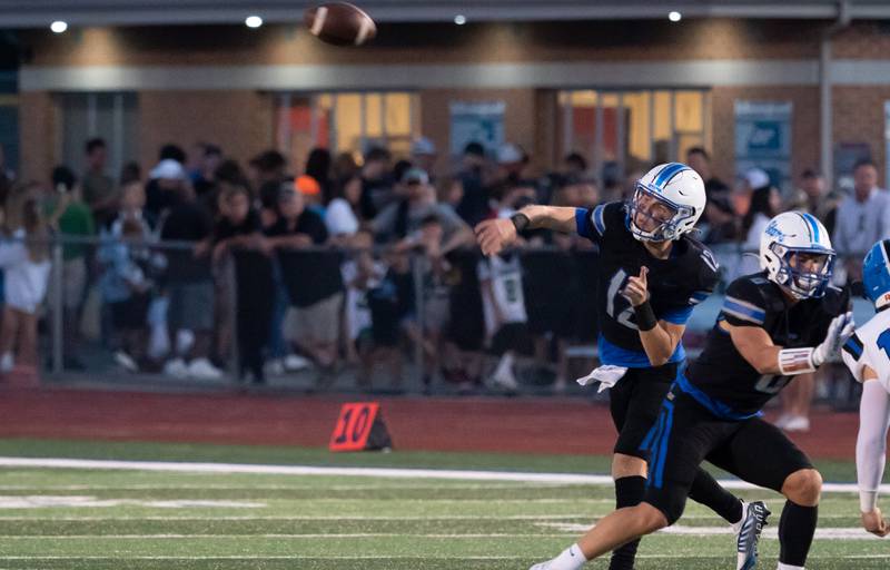 St. Charles North's Will Vaske (12) throws a pass against Lake Zurich during a football game at St. Charles North High School on Friday, Sep 2, 2022.