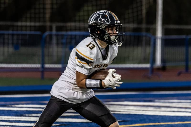 Metea Valley's Marcus Sewart returns the ball during a varsity football game against Lincoln-Way East at Lincoln-Way East on Oct. 30, 2025.