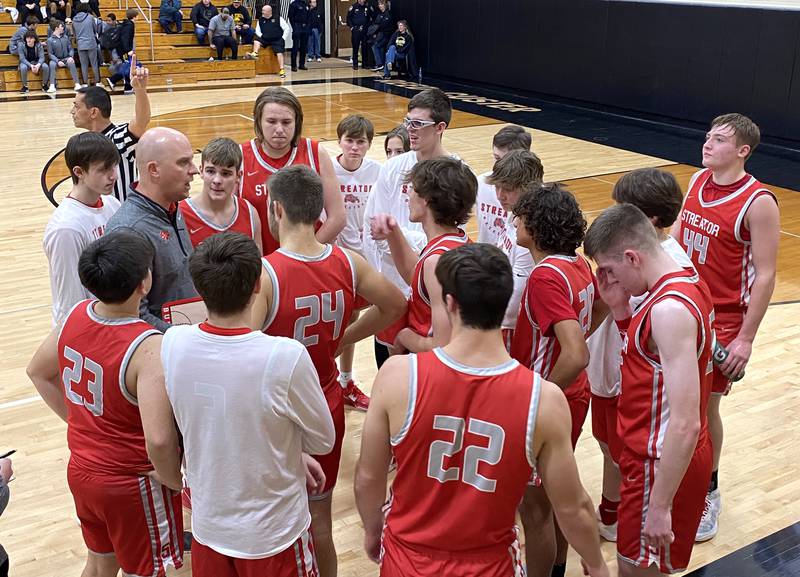 Streator coach Beau Doty (at left) instructs his Bulldogs during a timeout Thursday, Jan. 12 , 2023, in Braidwood.