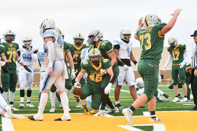 Coal City's Landin Benson is helped up after scoring a touchdown Saturday, Nov. 23, 2024, during the Coalers' 21-14 loss to DePaul in the IHSA Class 4A Playoffs semifinal game.