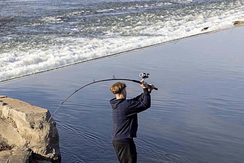 Avery Winge of Sterling casts Wednesday, Dec. 20, 2023 while trying his luck at the lower dam in Rock Falls. The mild weather was great for fishing but bad for a potential white Christmas.