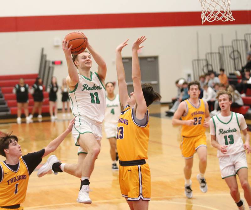 Rock Falls's Gavin Sands drives to the basket past Mendota's Cale Strouss and teammate Dane Doyle during the 49th annual Colmone Classic on Friday, Dec. 8, 2023 at Hall High School.