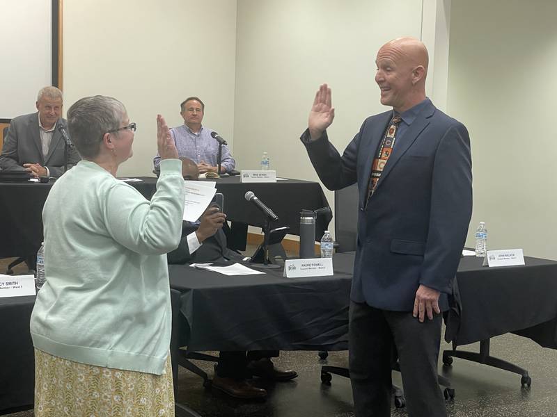 Justin Carlson (right) is sworn in May 12, 2025, at the DeKalb City Council meeting.