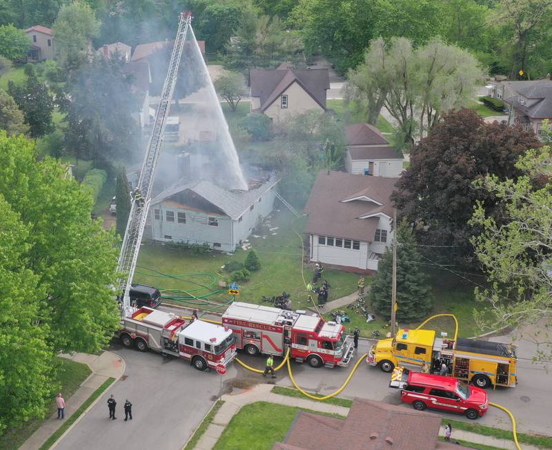Firefighters use an aerial ladder truck to extinguish a structure fire in the 1900 block of Main Street on Monday, May 4, 2026 in Peru.